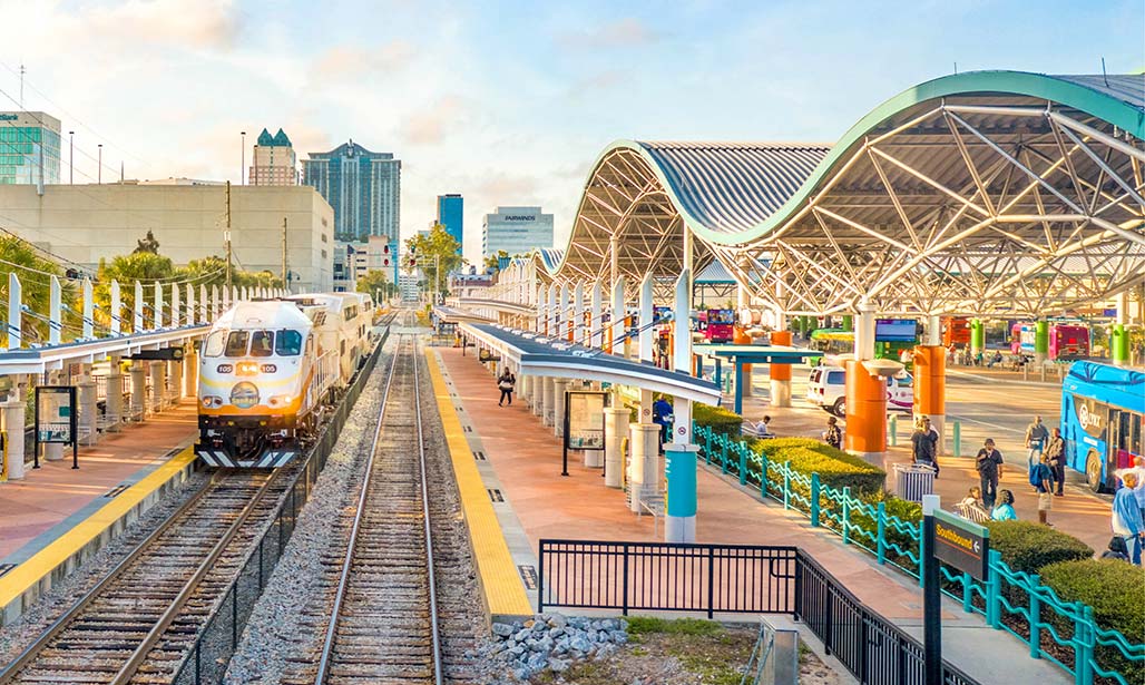 Slideshow: Sunrail train at Lynx Central Station showing train platform and bus tranportation.